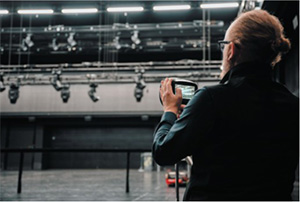 Person operating FLIR Si2 camera in a theater.